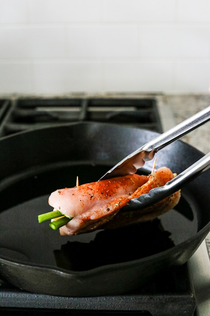 Asparagus Stuffed Chicken Breasts searing in a pan