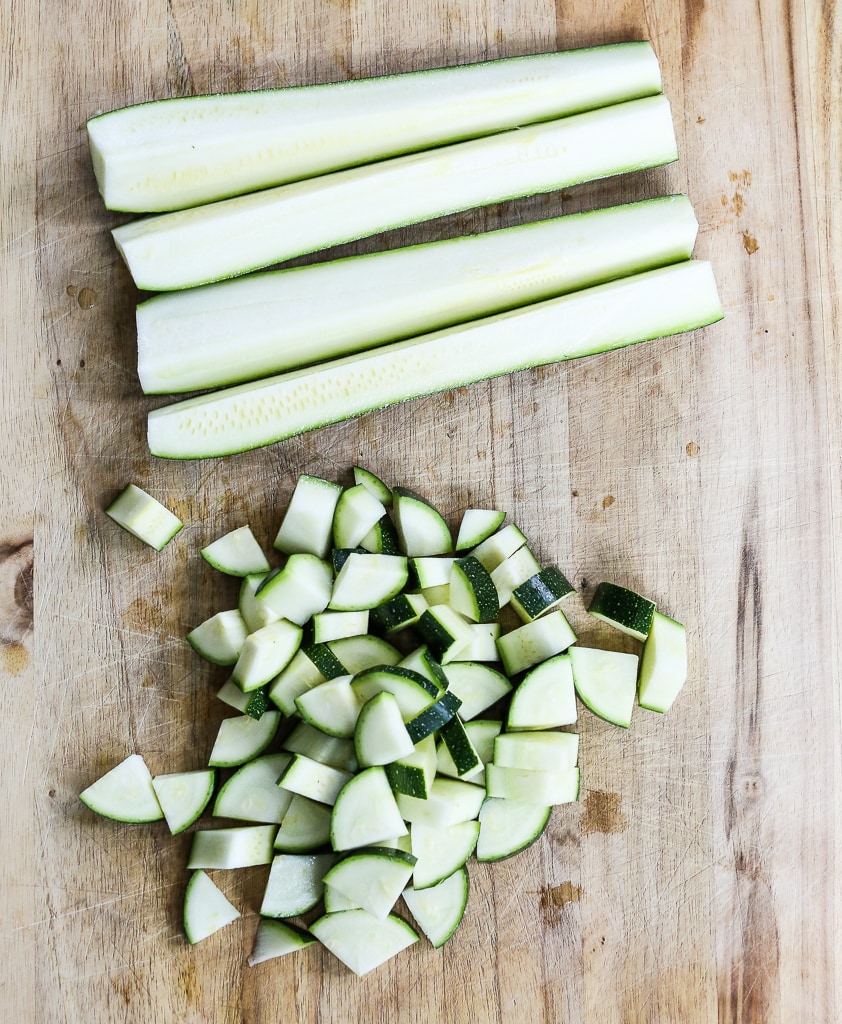 cutting zucchini on a cutting board