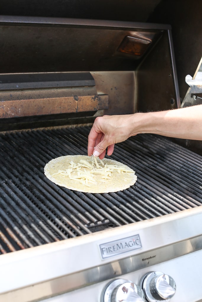 adding cheese to Grilled Zucchini Quesadilla