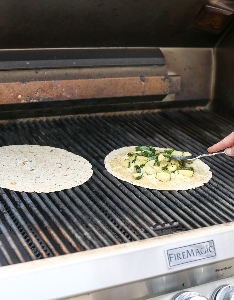 adding zucchini to tortilla