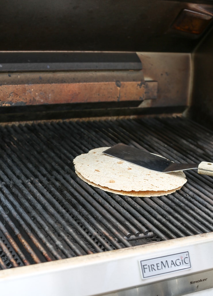 pressing tortilla down with a spatula