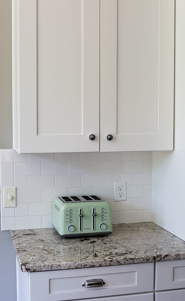 a mint green toaster on a counter