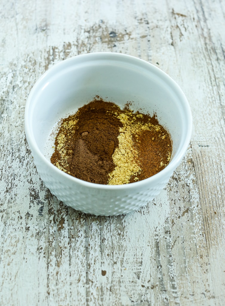 ingredients for Homemade Pumpkin Pie Spice Recipe in a white bowl