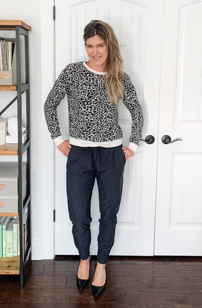 A woman in joggers with heels