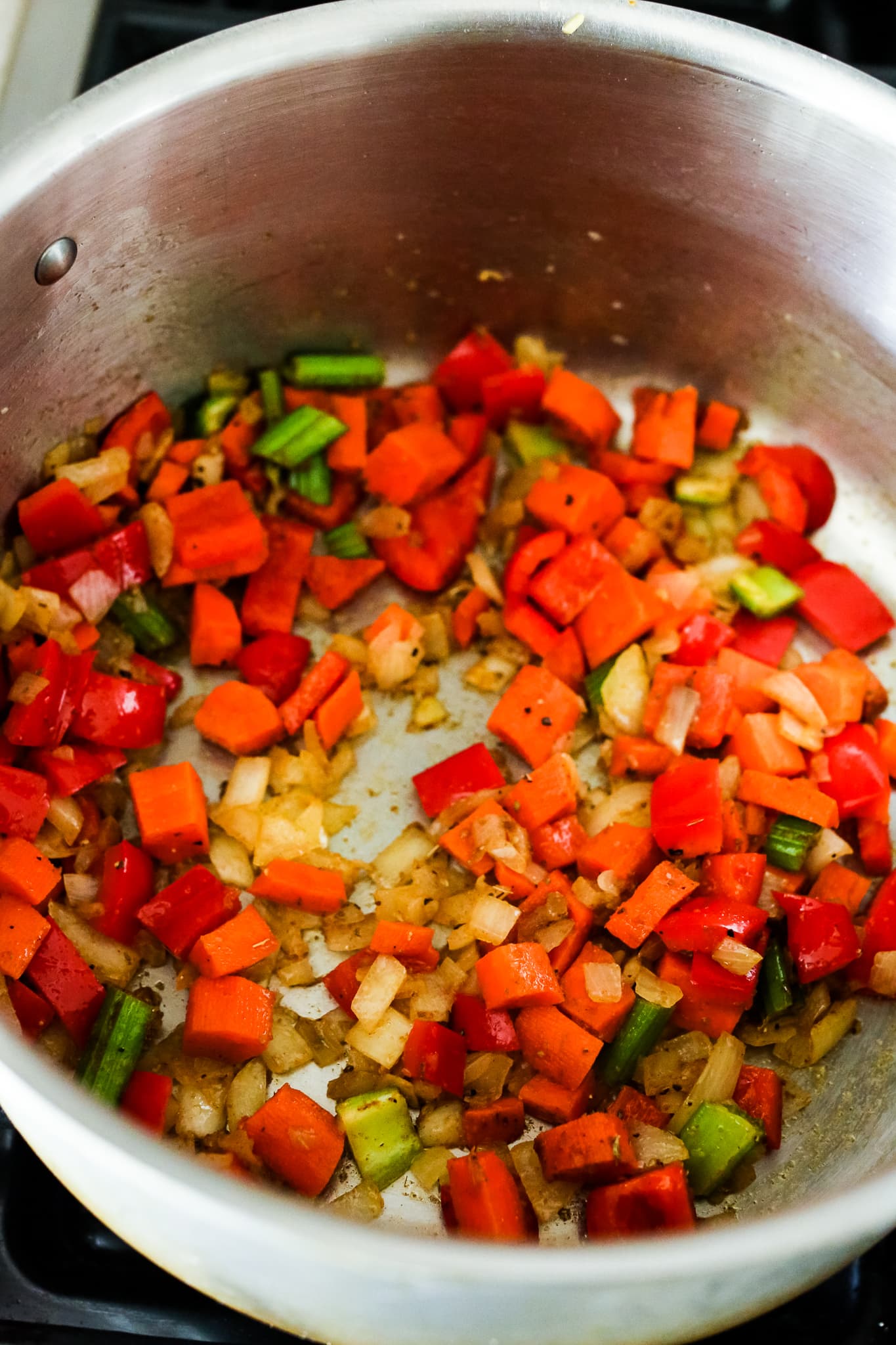 vegetables in a soup pot being sauteéd