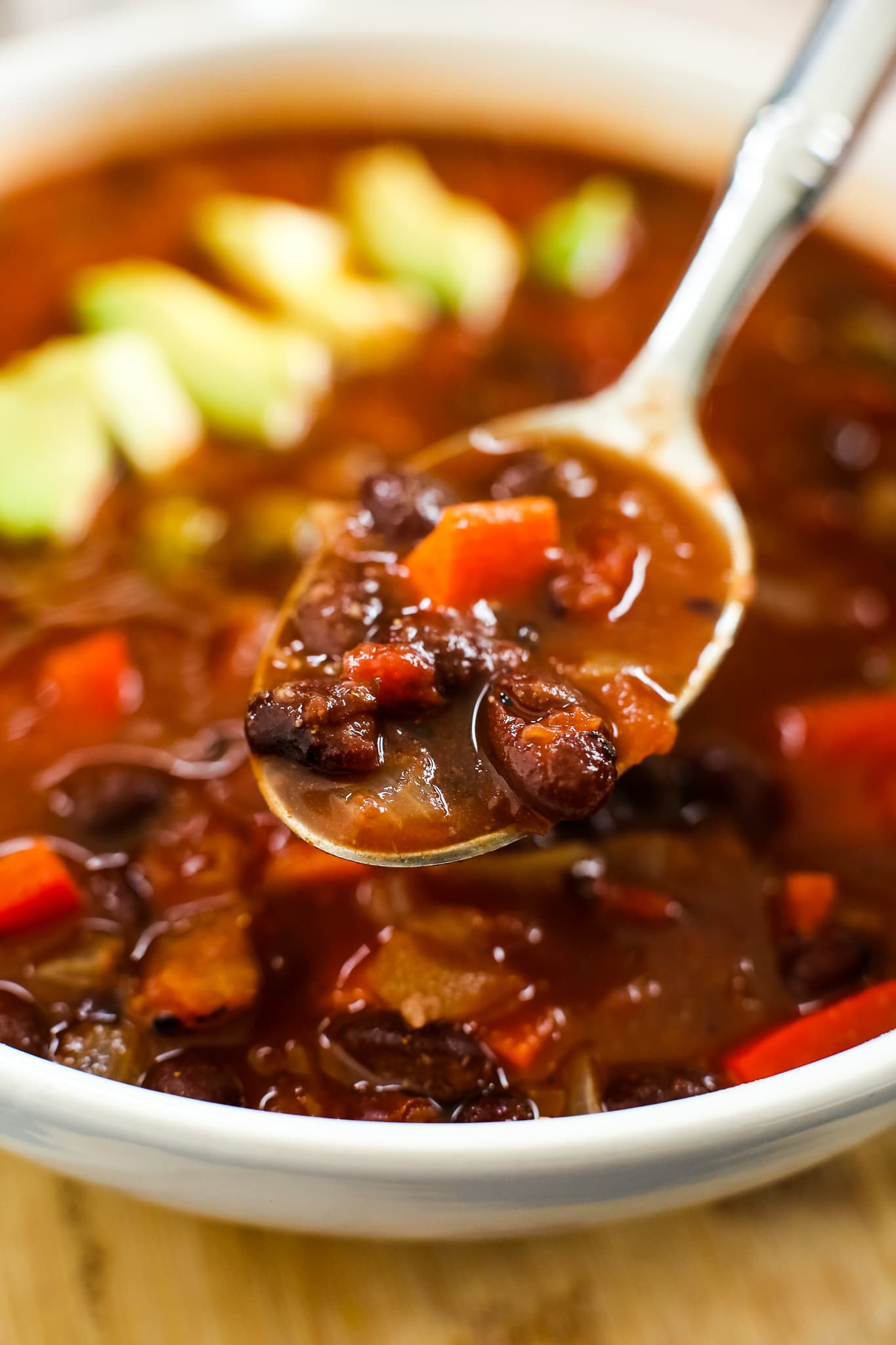 a spoonful of soup with black beans