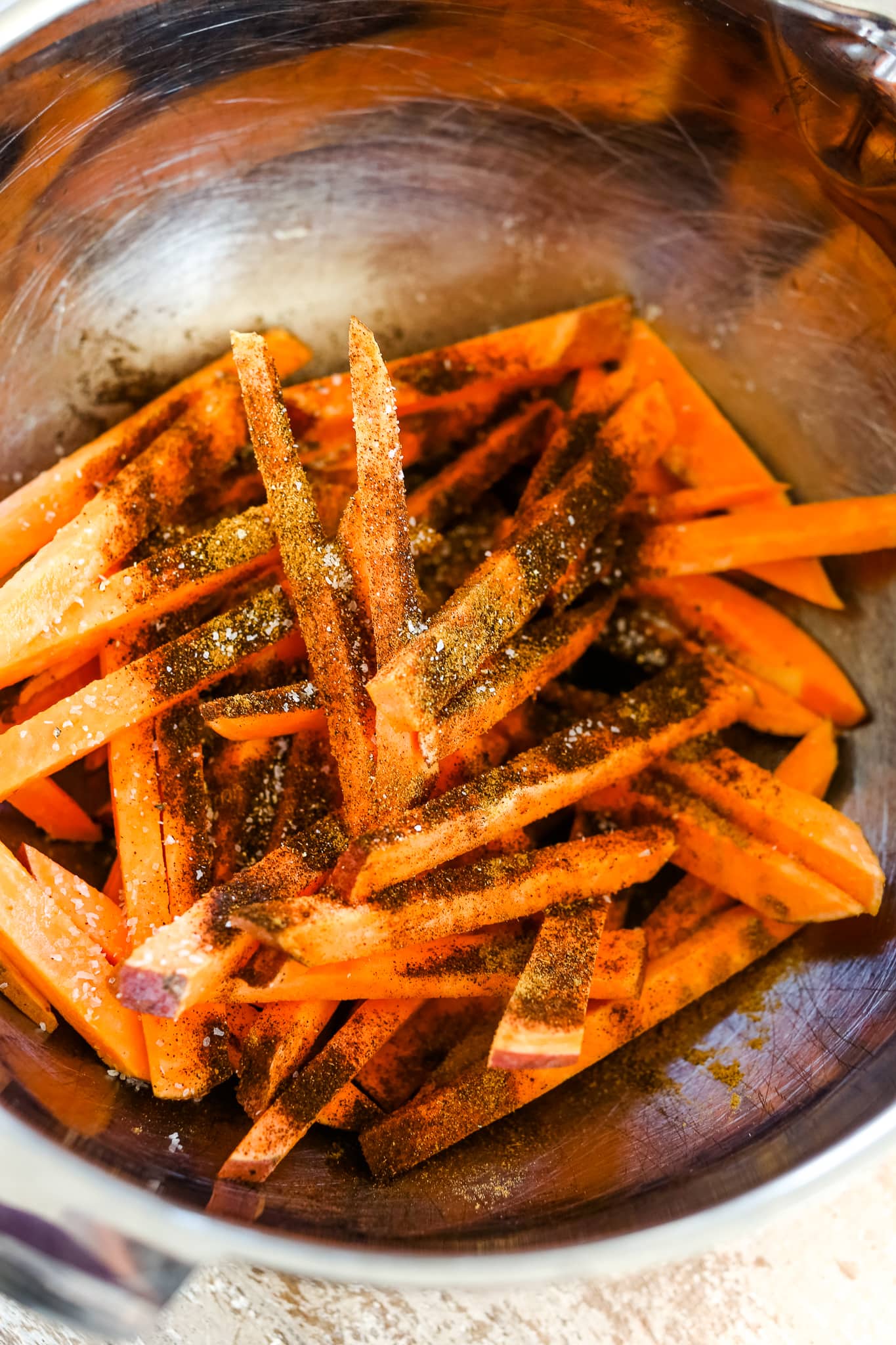 sweet potato fries in a bowl with seasoning