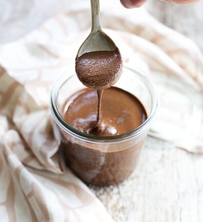 chocolate almond butter dripping off of a spoon
