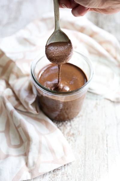 chocolate almond butter dripping off of a spoon
