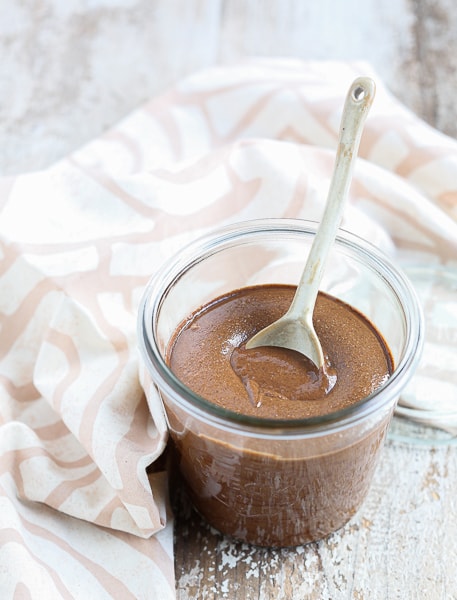 Chocolate Almond Butter recipe with a spoon in the glass jar