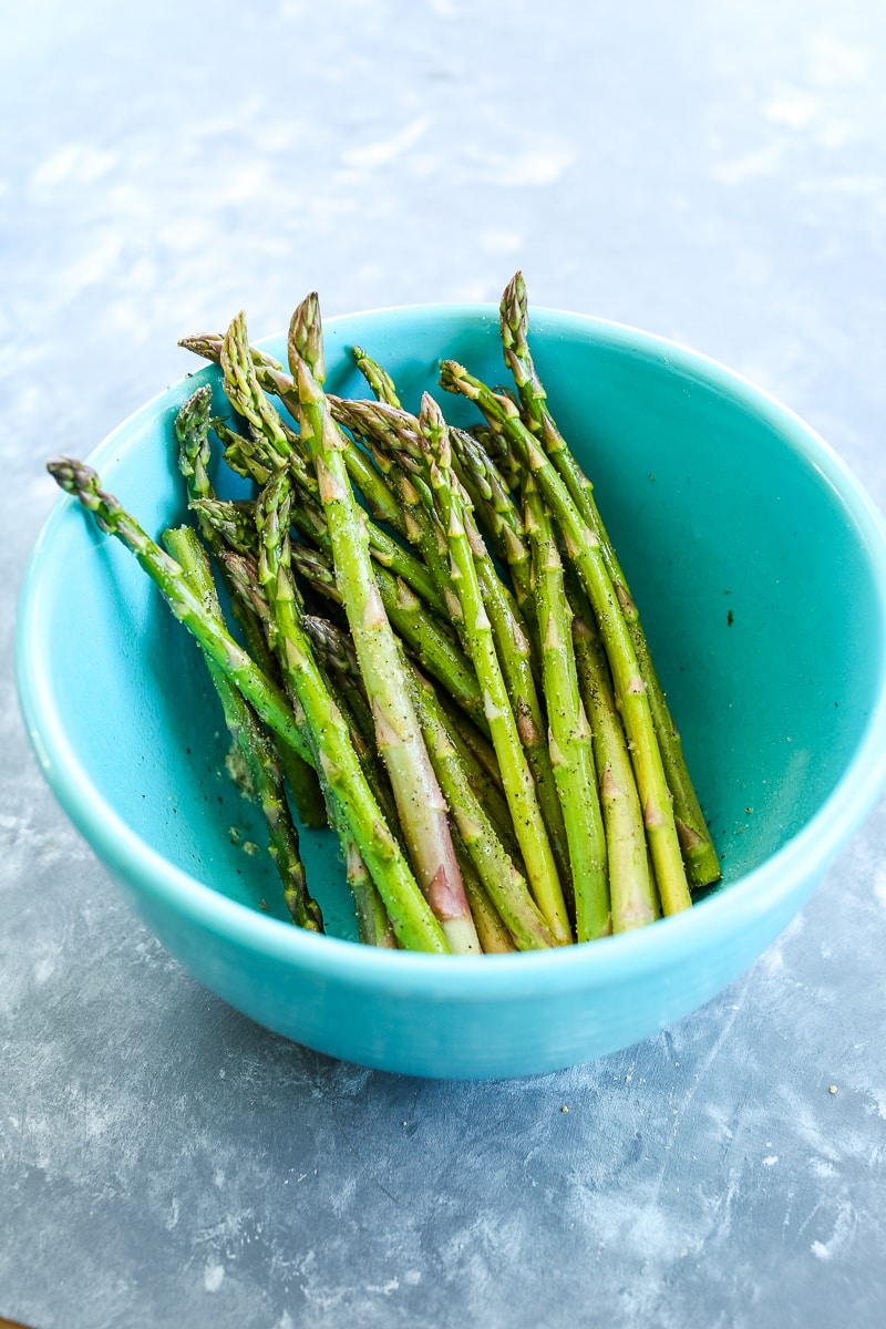 asparagus in a bowl coated with spices
