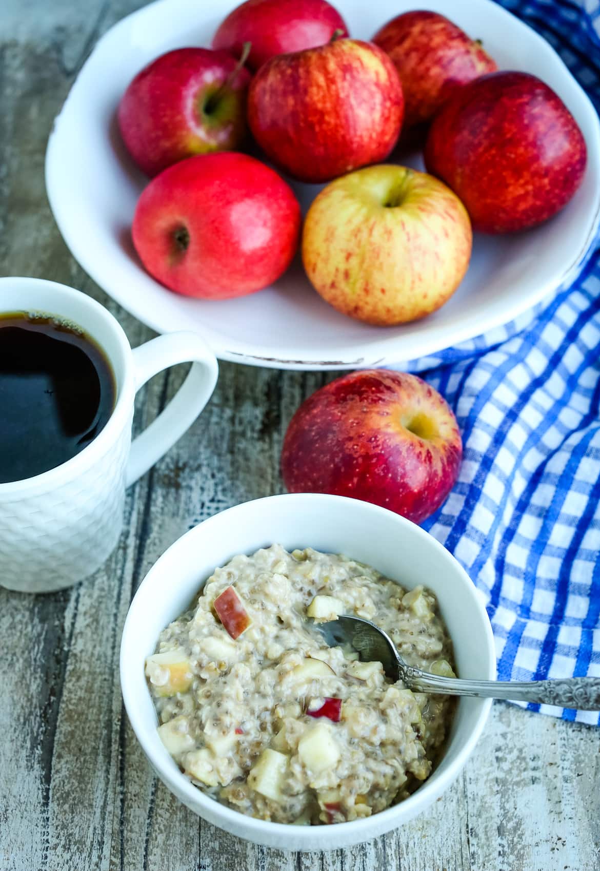 overhead shot of Apple Pie overnight oats, a cup of coffee, and a bowl of apples