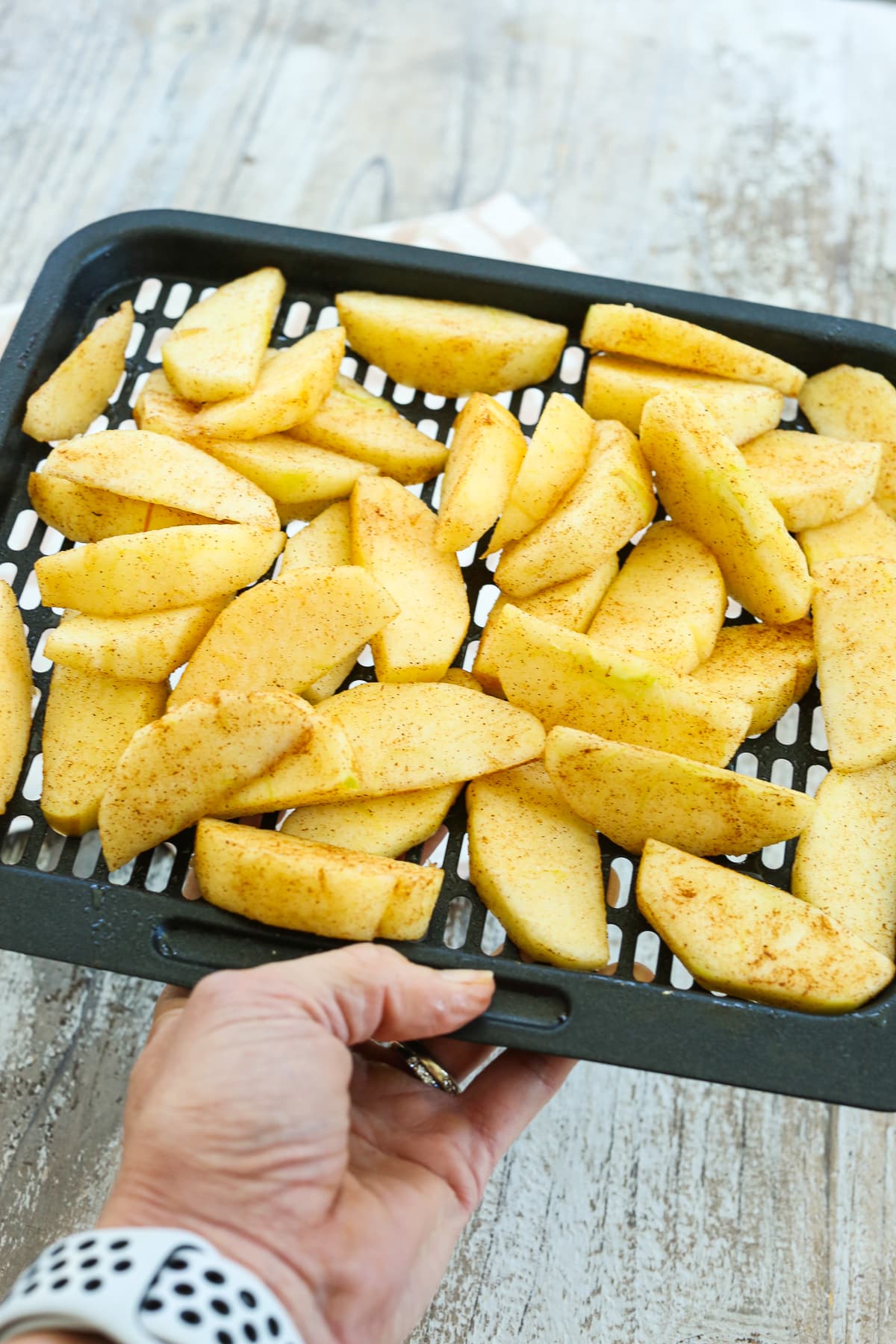 making air fryer apples--apple slices on a tray