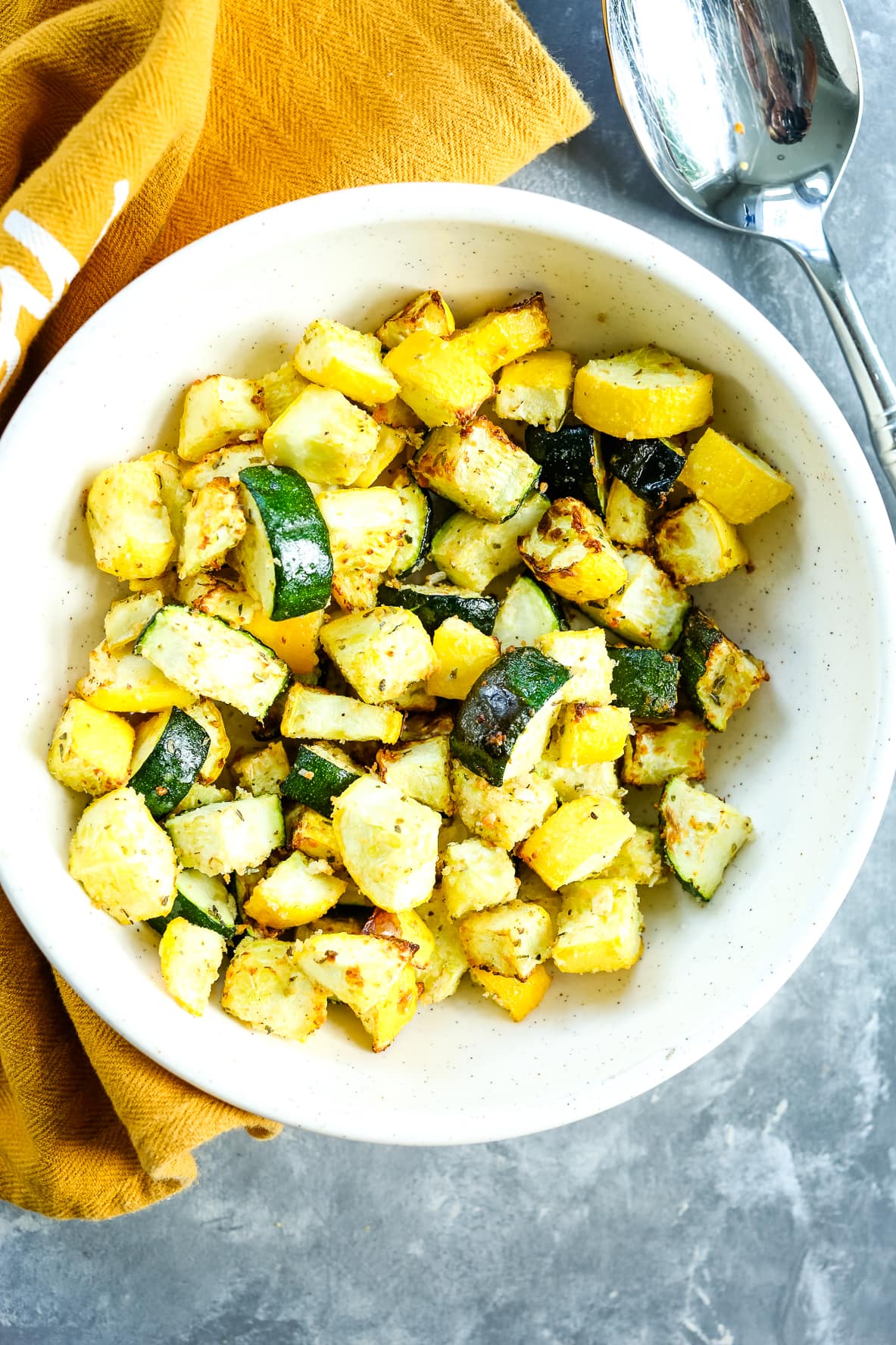 overhead shot of air fryer zucchini and squash with a brown napkin