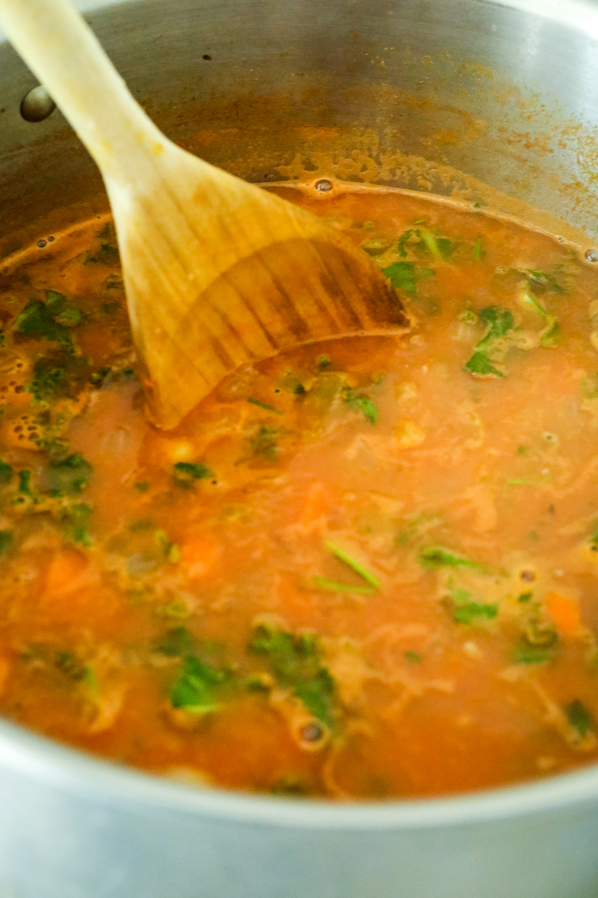 stirring kale into soup