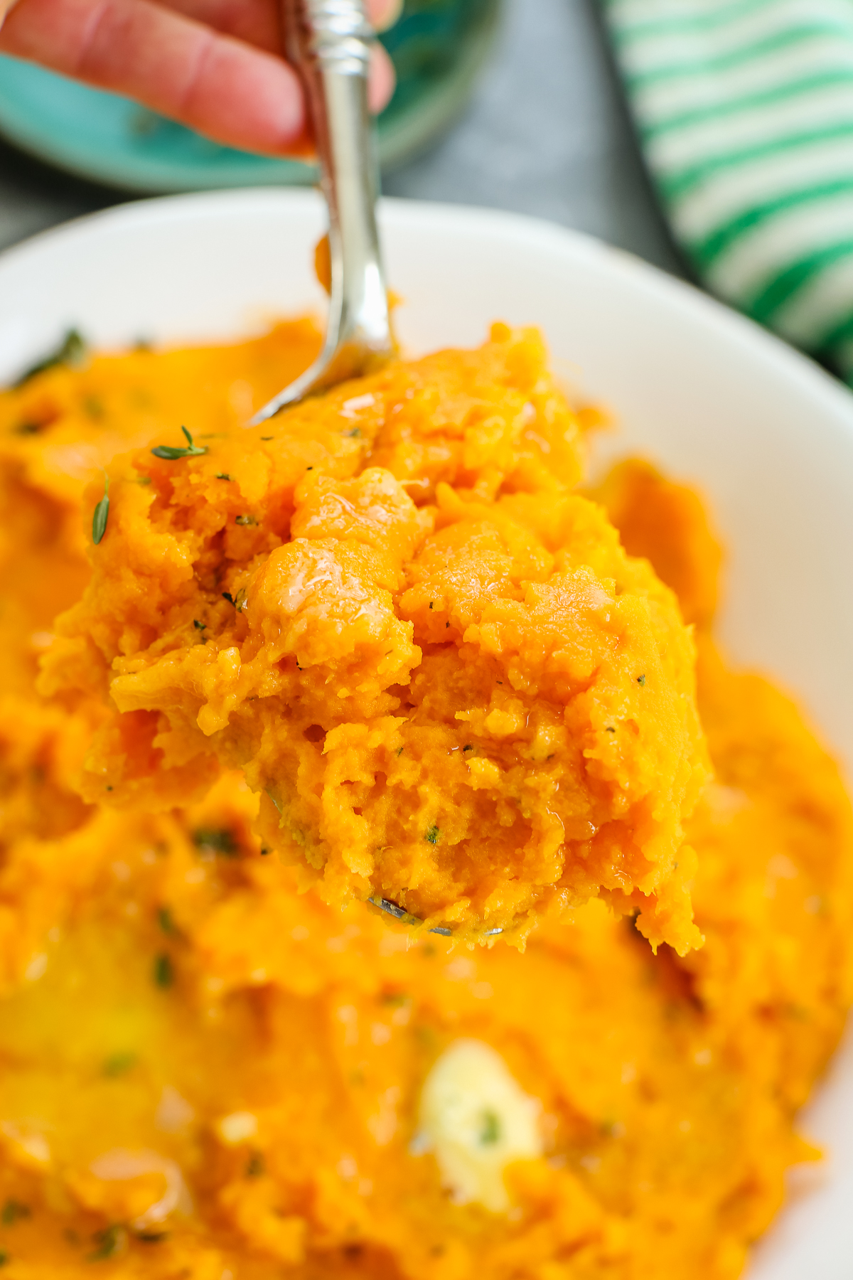 serving savory mashed sweet potatoes from a spoon
