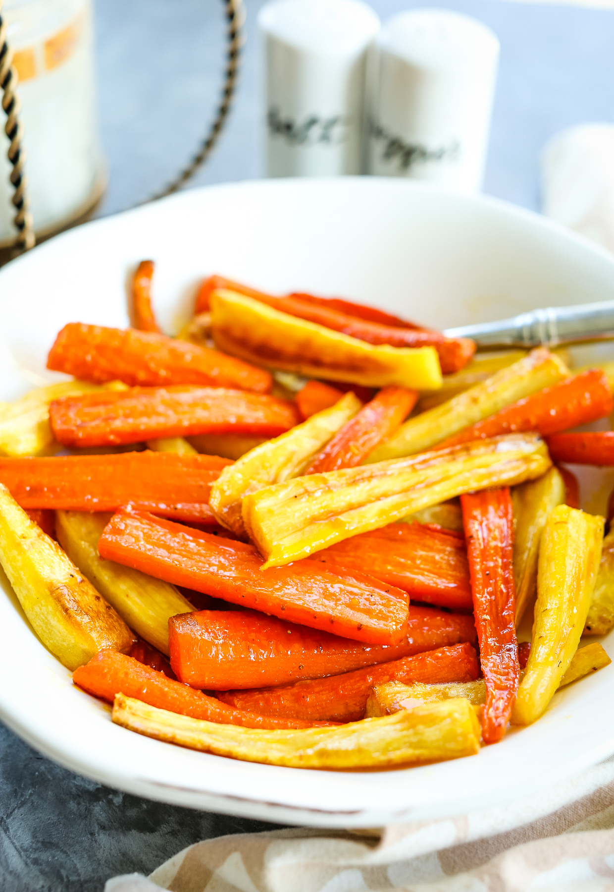honey roasted carrots and parsnips recipe in a white bowl 