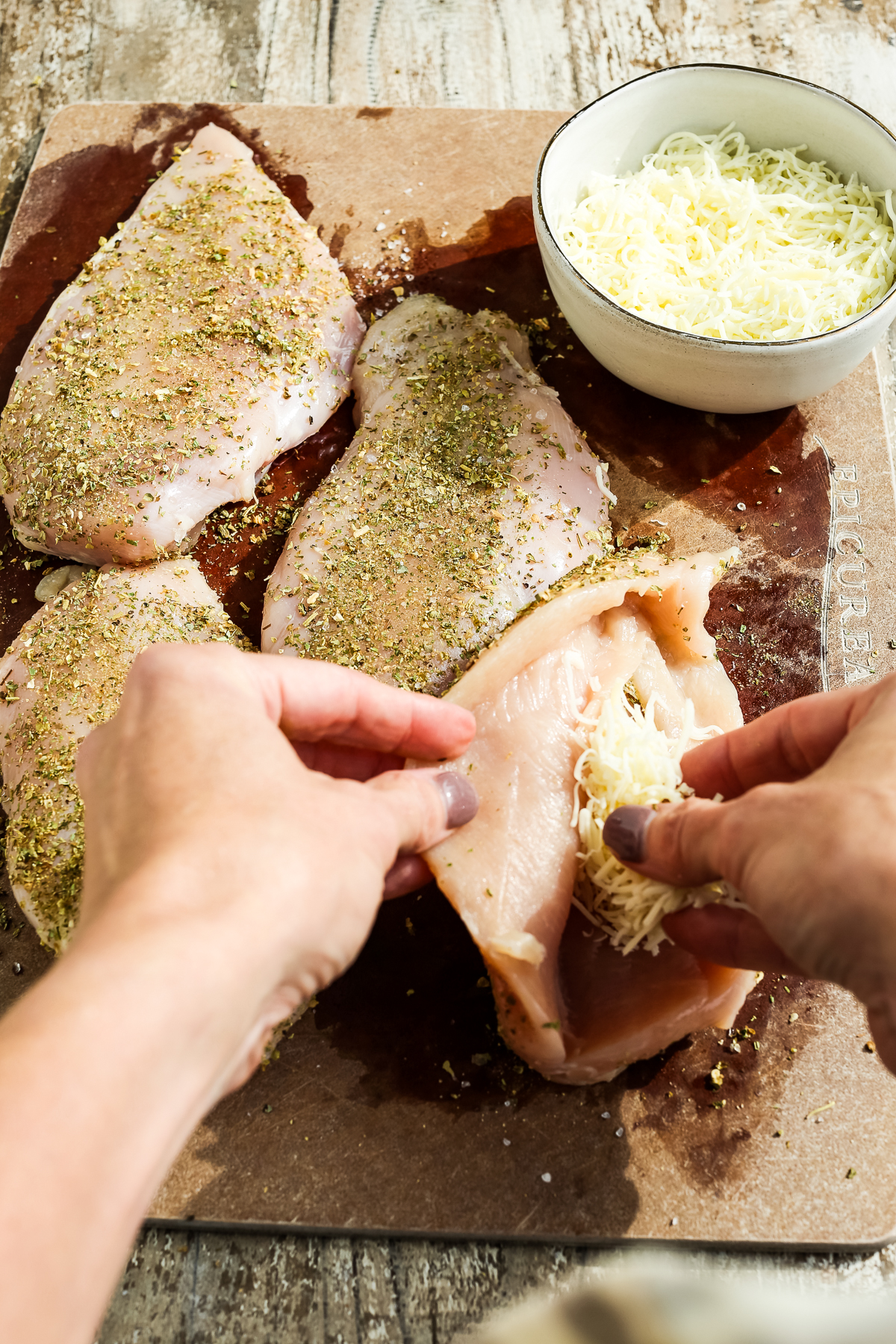 stuffing cheese into a raw chicken breast