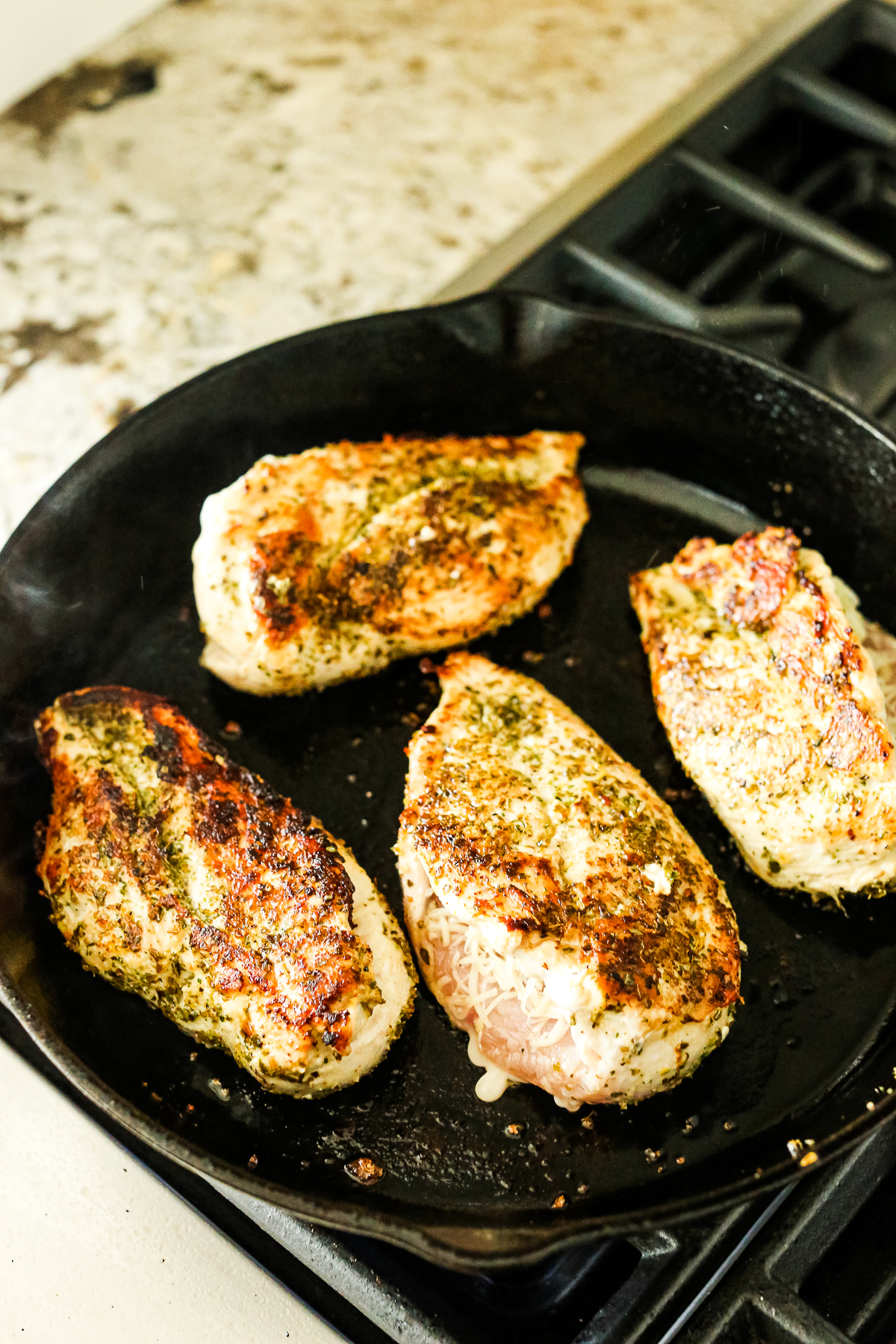 4 chicken breasts in a pan with a golden brown sear