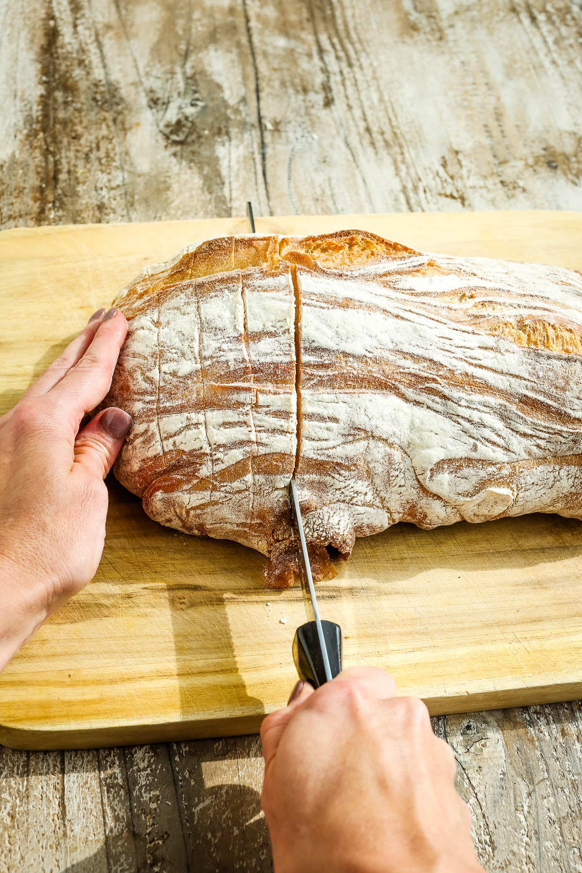 cutting a loaf of Ciabatta bread