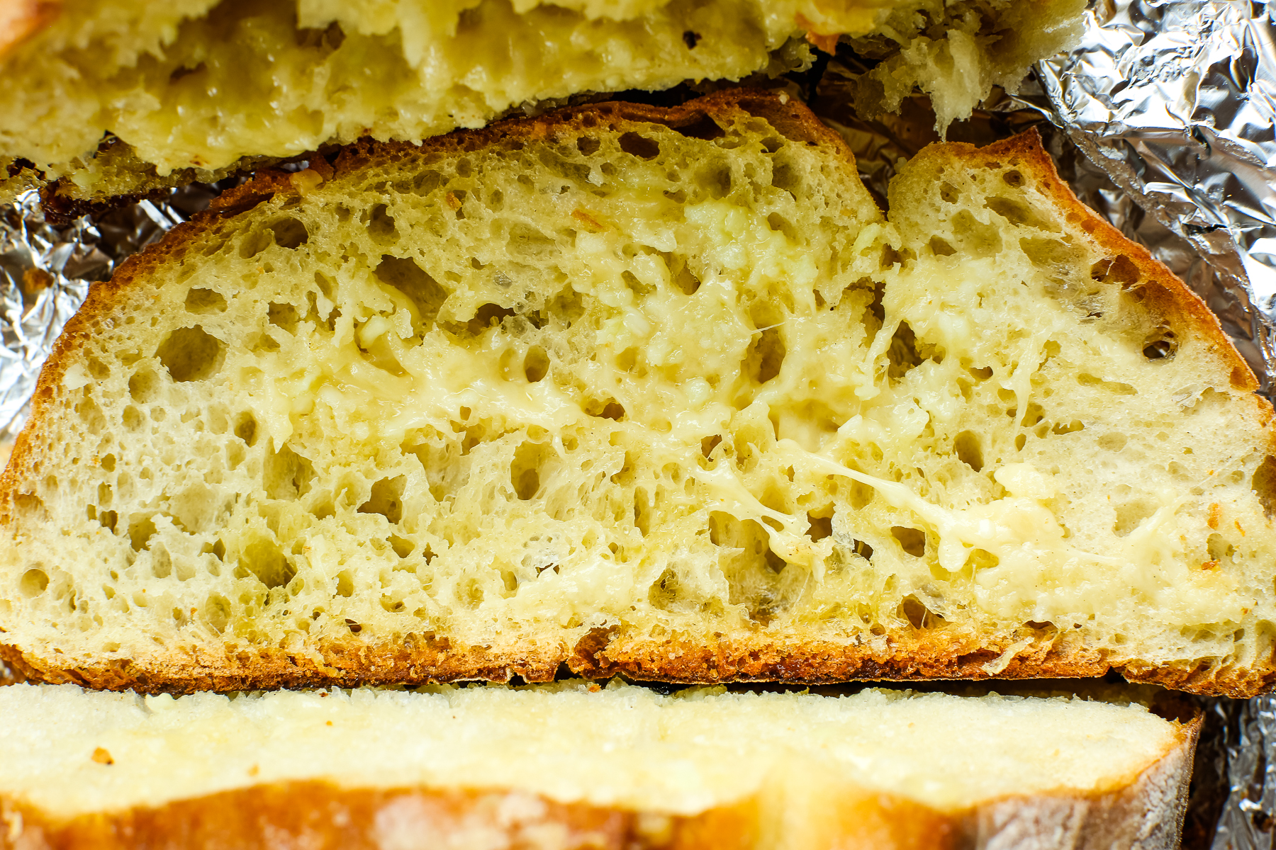 an up close photo of a piece of garlic bread