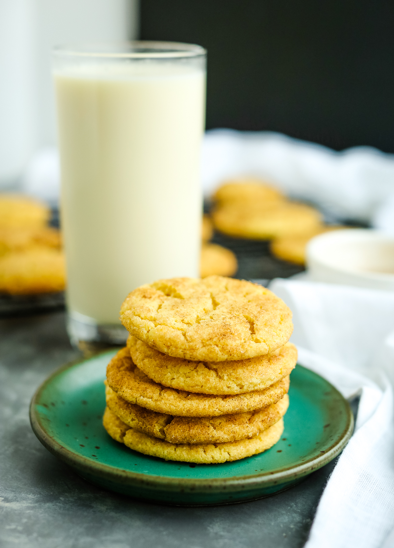 Brown Butter Snickerdoodles on a green plate with milk 