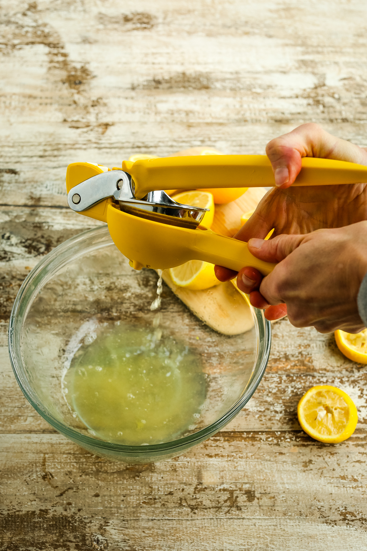 a yellow citrus juicer juicing lemons