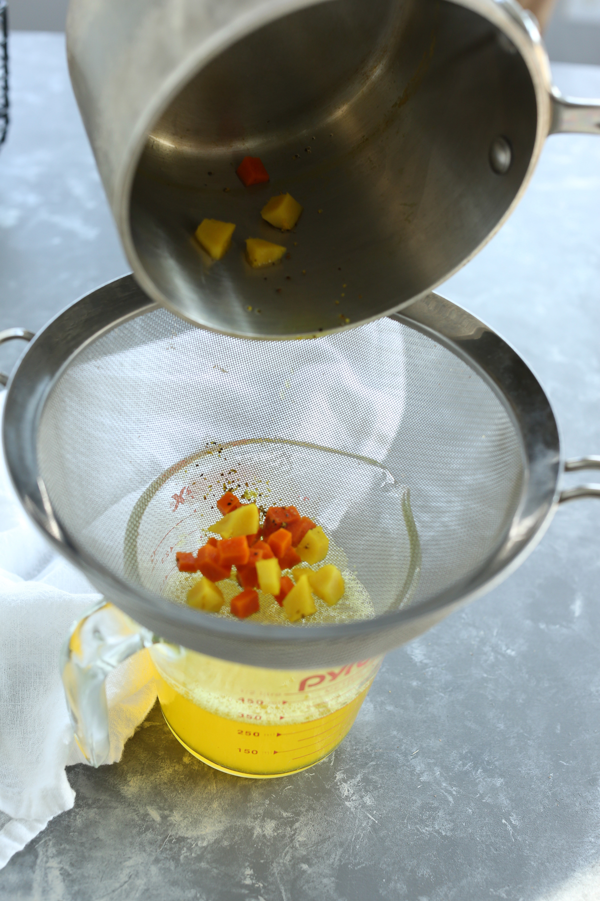 straining turmeric and ginger from water