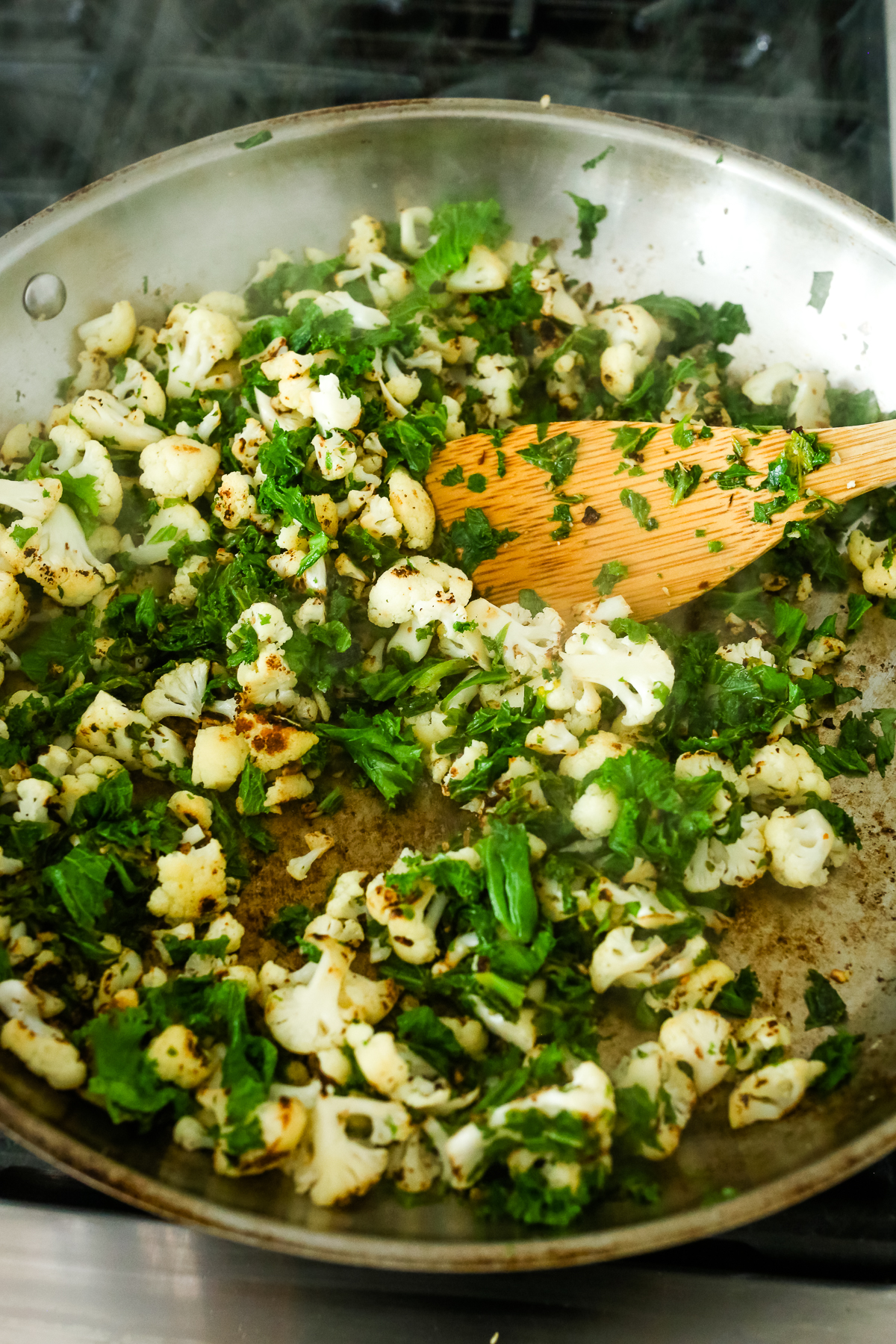 cauliflower with mustard greens in a pan