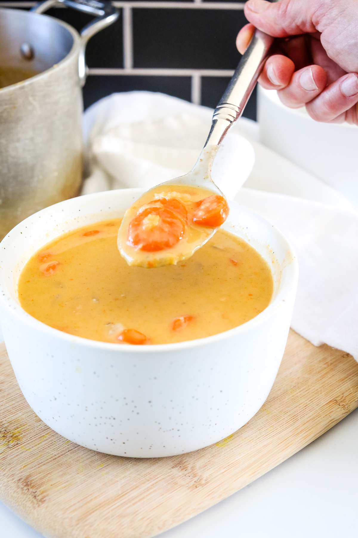 Carrot and Lentil Soup on a spoon from a white bowl