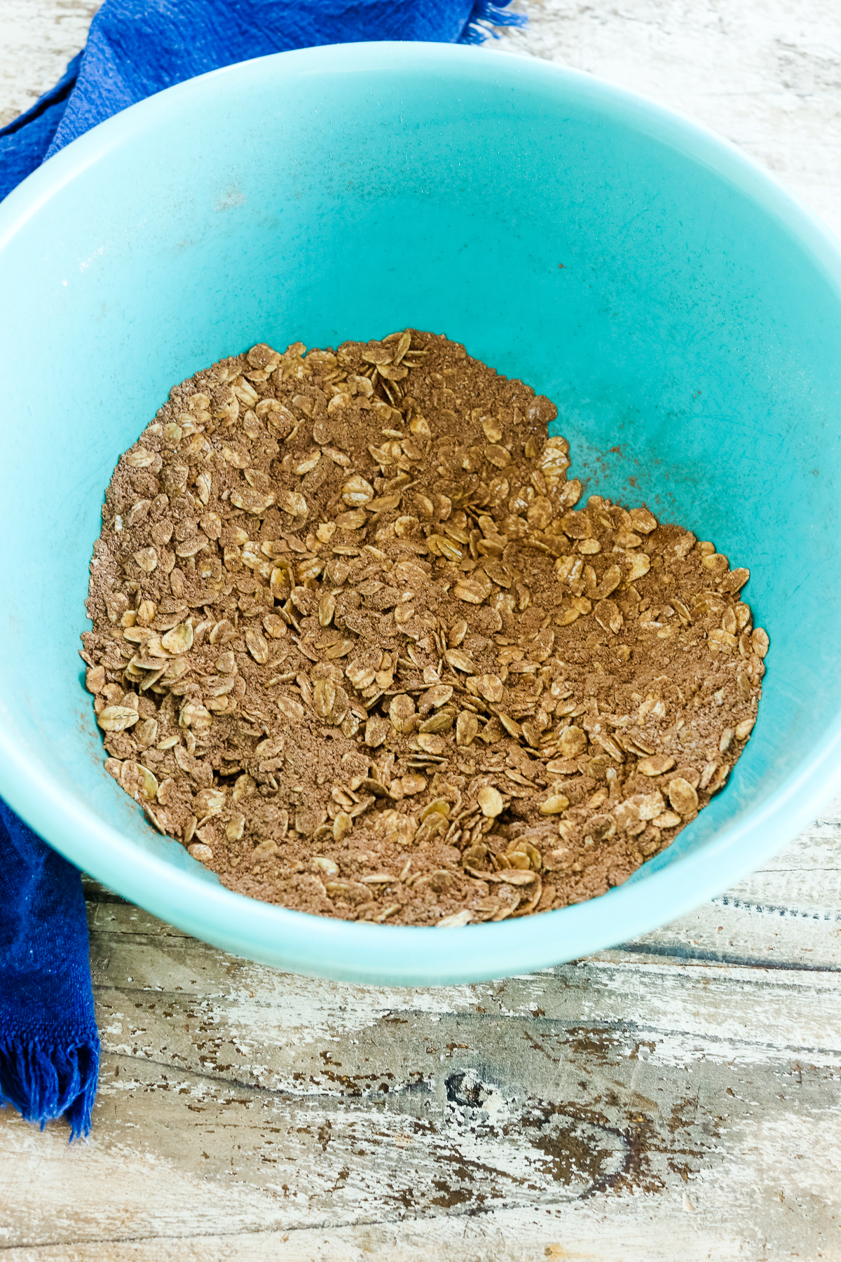 oats and cocoa powder mixture in a turquoise bowl