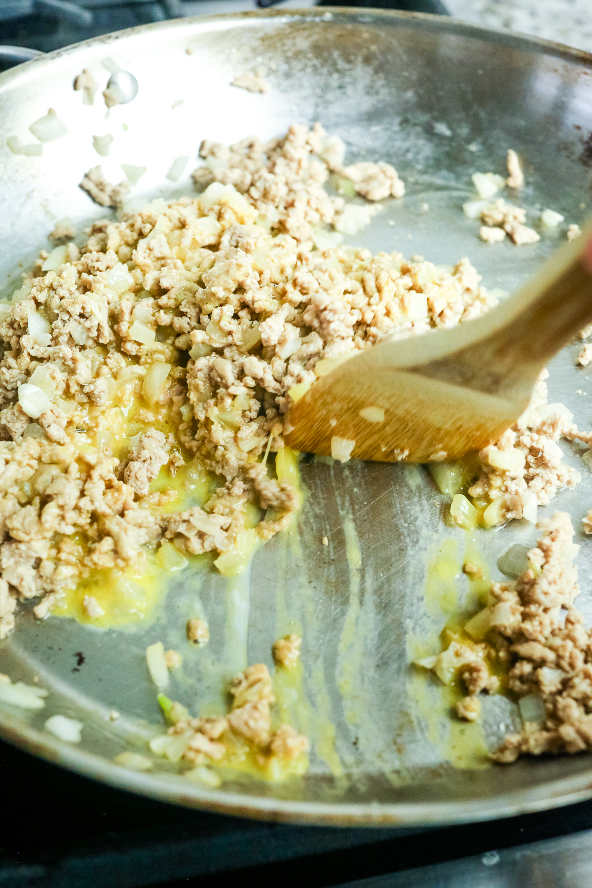 a spatula moving eggs in a pan 