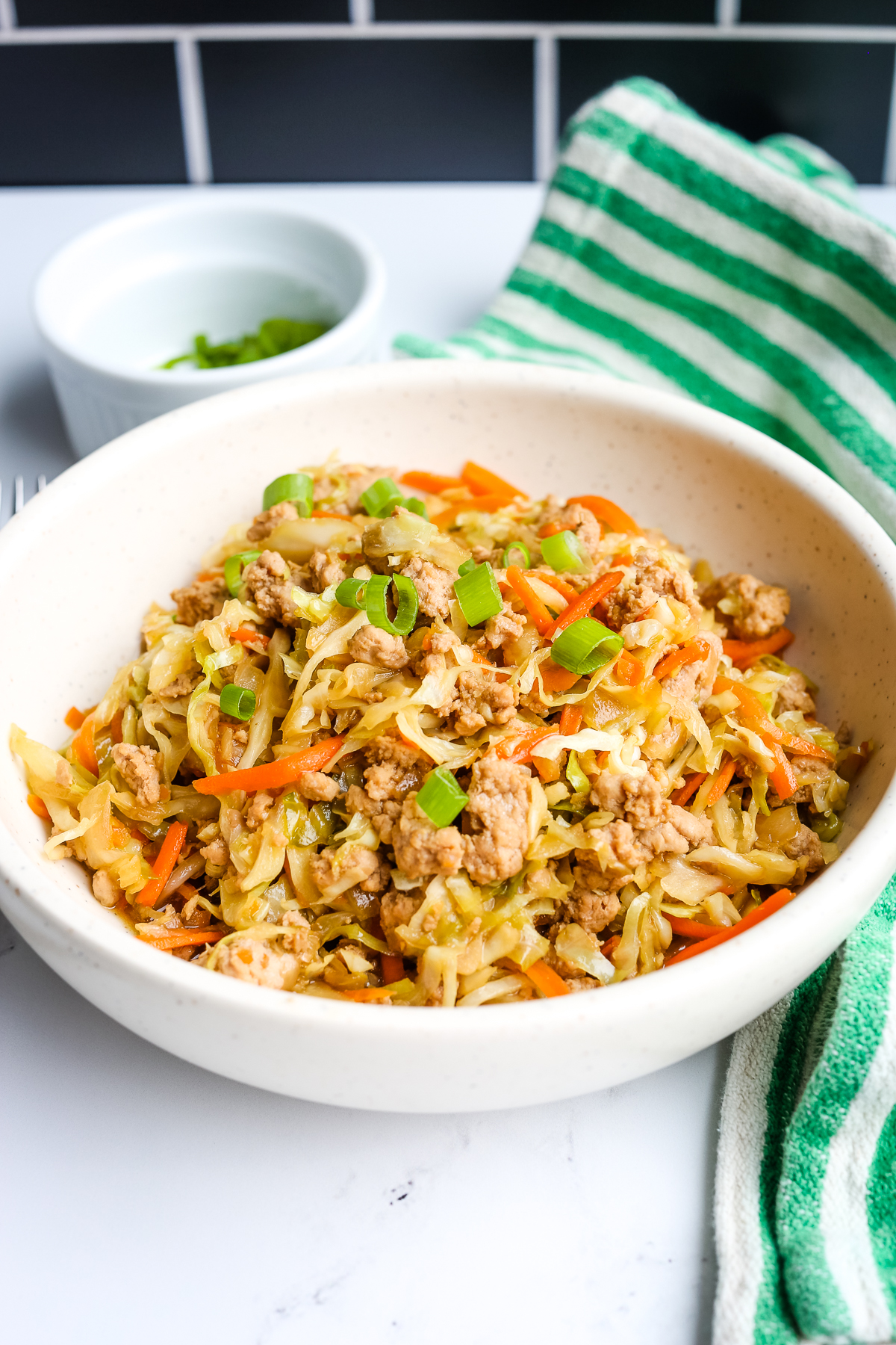 Egg Roll in a bowl with a green and white striped napkin