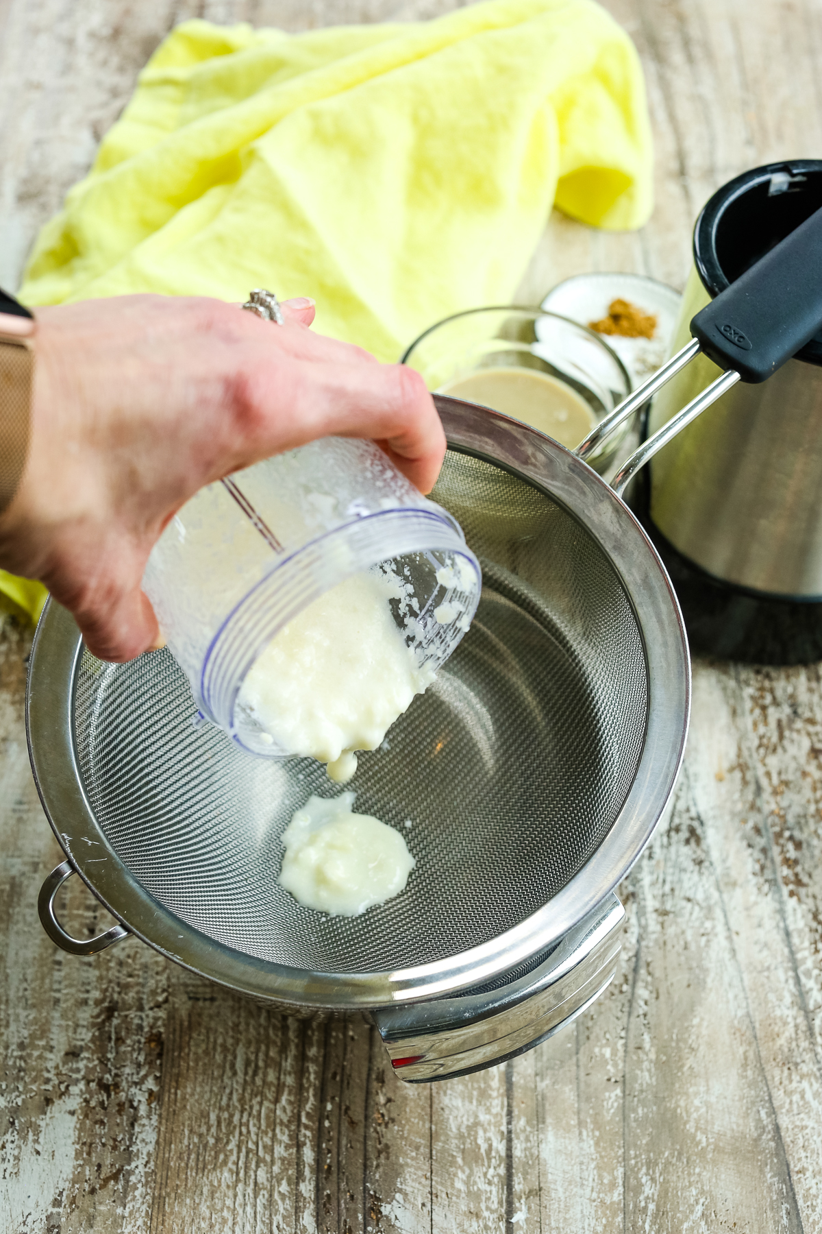 putting garlic paste through a sieve