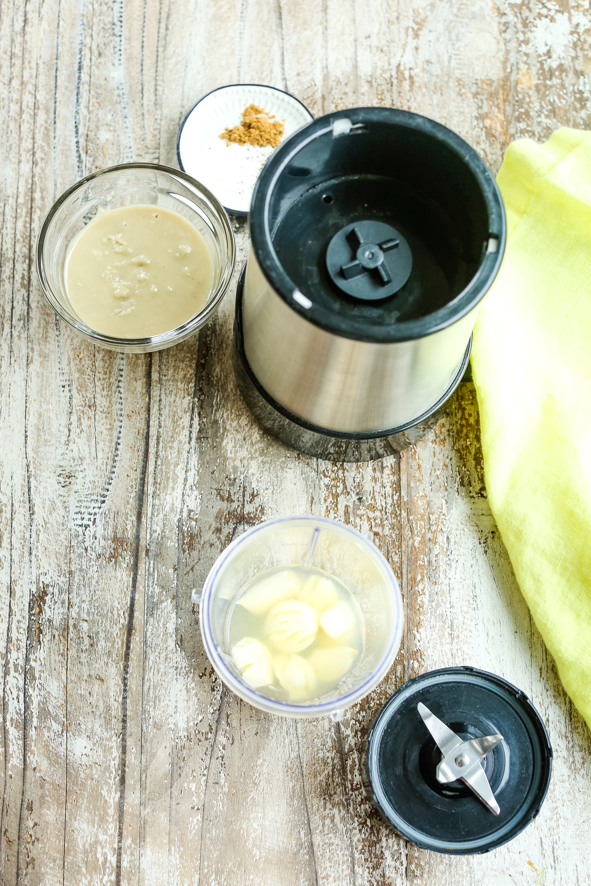 garlic and tahini next to a small blender