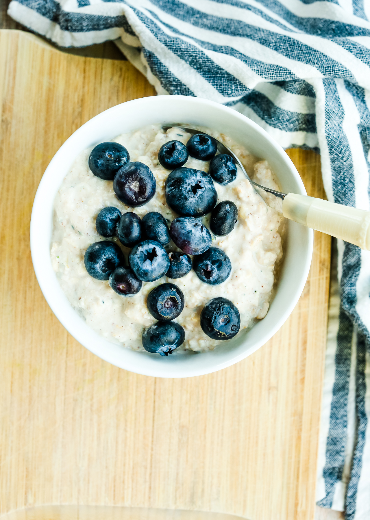 an overhead shot of a bowl of overnight oats topped with blueberries