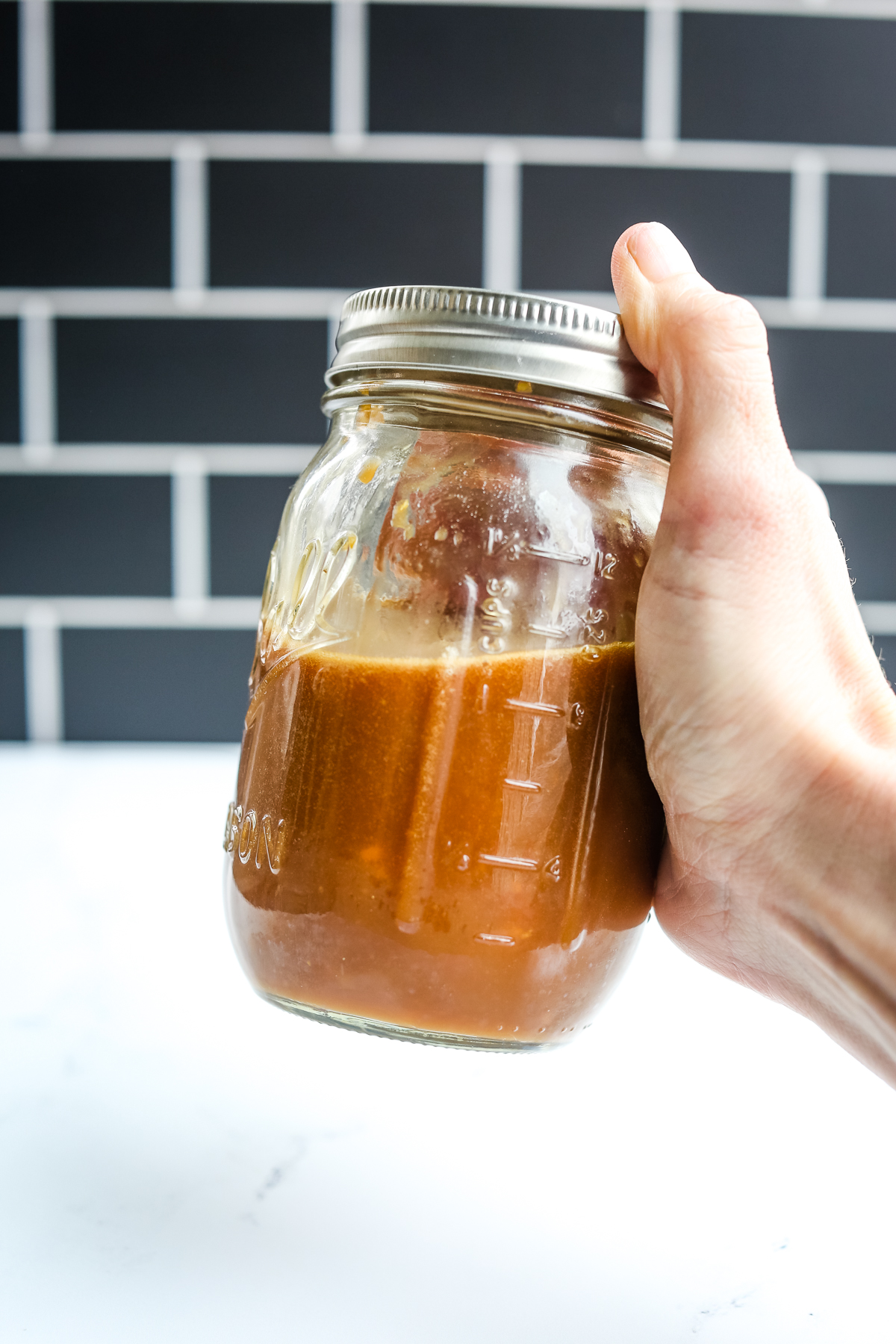 shaking a jar with healthy stir fry sauce