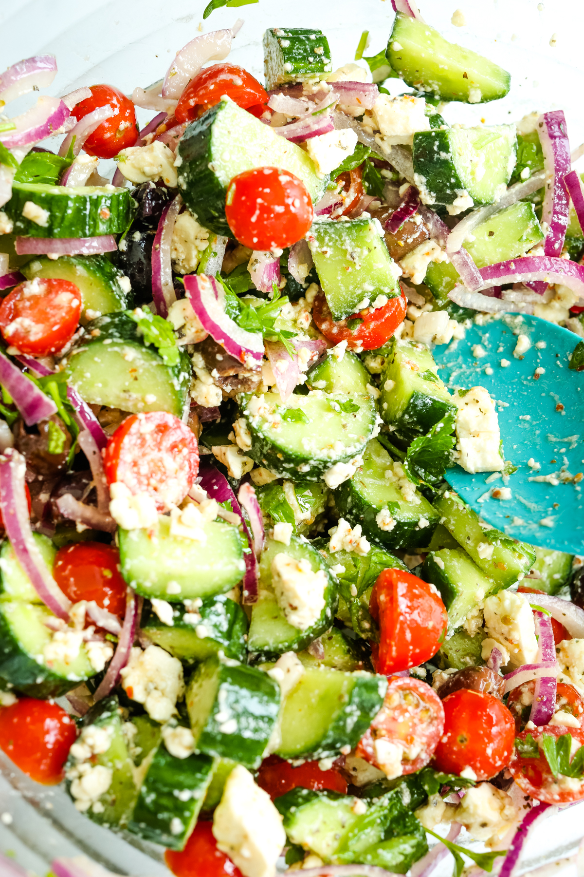 stirring feta into salad ingredients