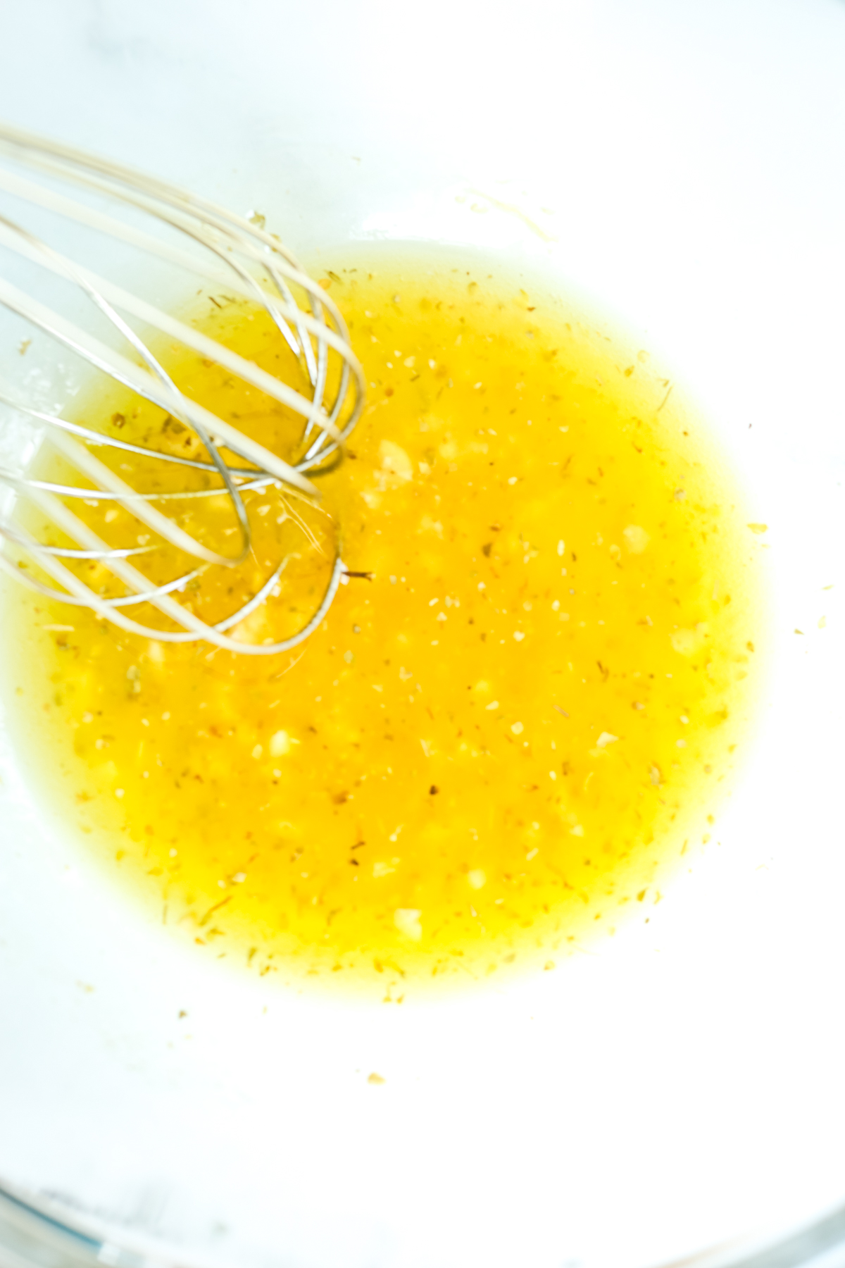 dressing in a bowl being whisked