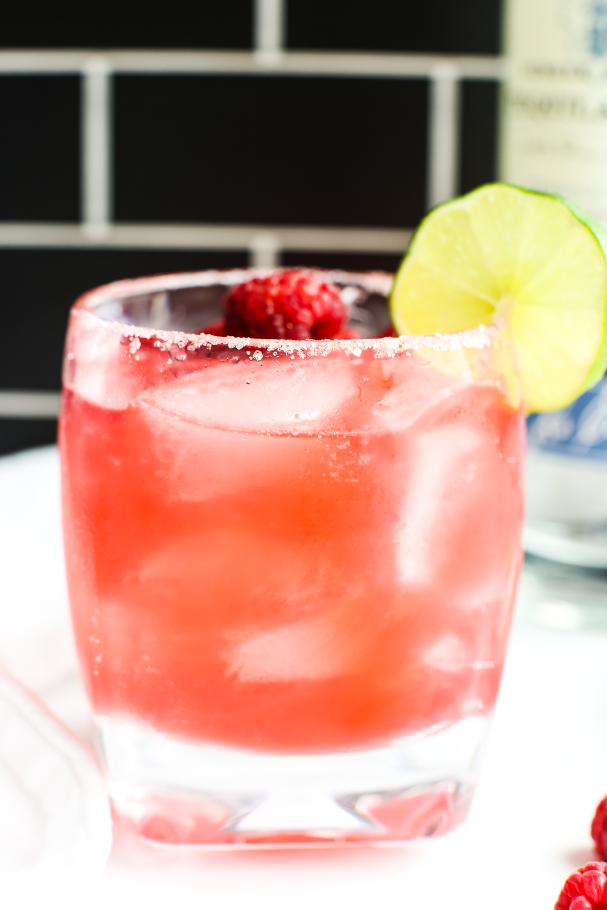 Raspberry Margarita garnished with a lime