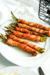 Air Fryer Bacon Wrapped Asparagus on a white plate