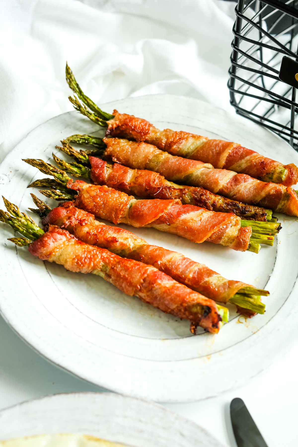 Air Fryer Bacon Wrapped Asparagus on a white plate