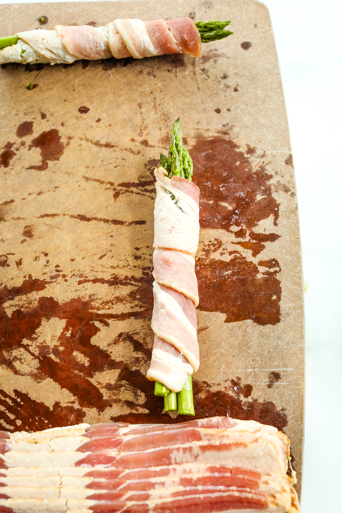 wrapping bacon around 3 asparagus spears