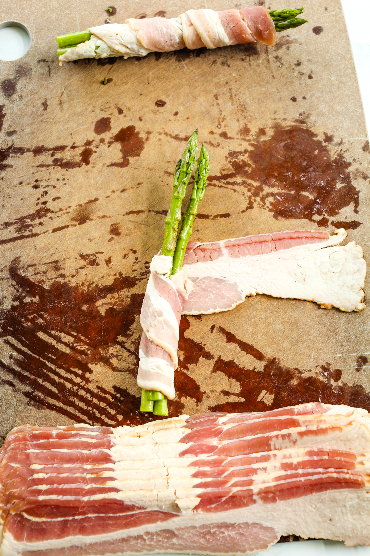 wrapping bacon around 3 asparagus spears