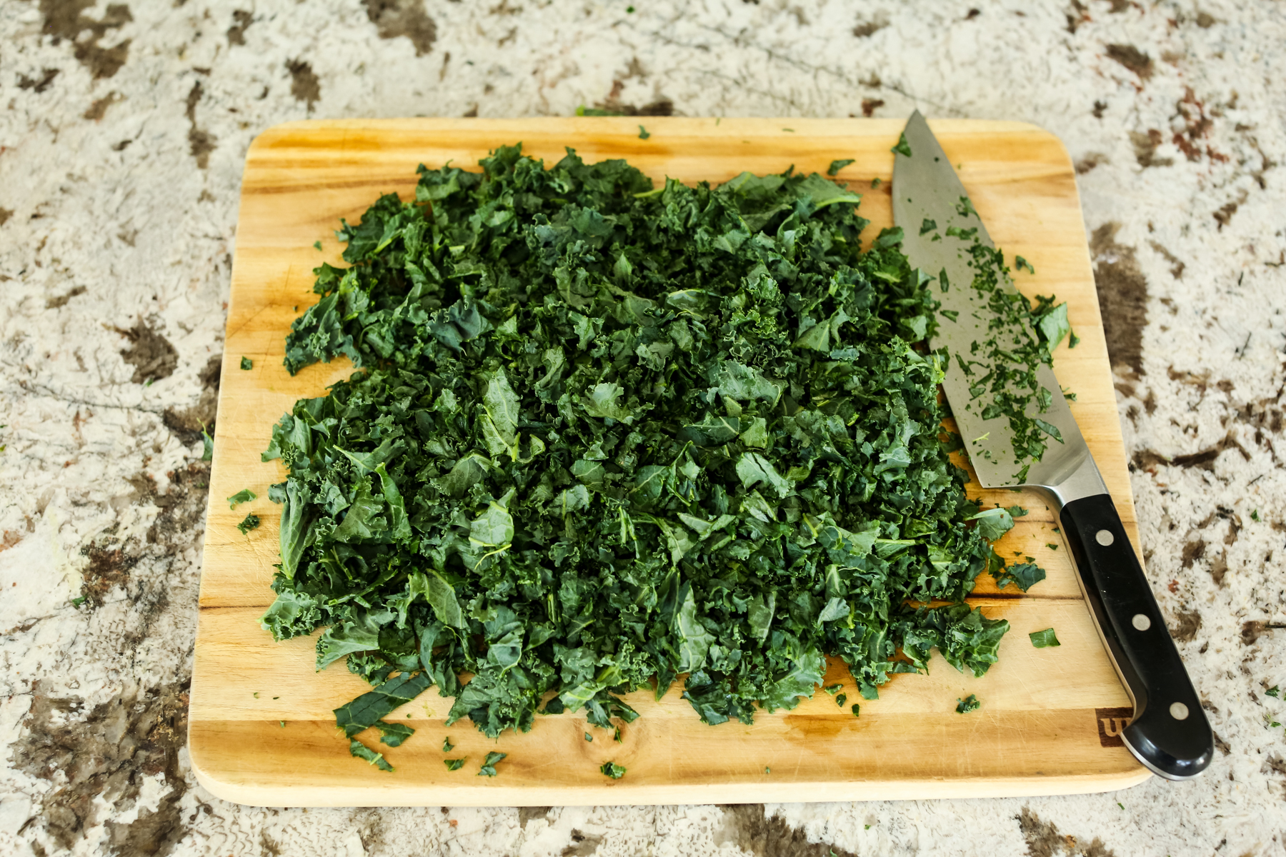 chopped kale on a cutting board