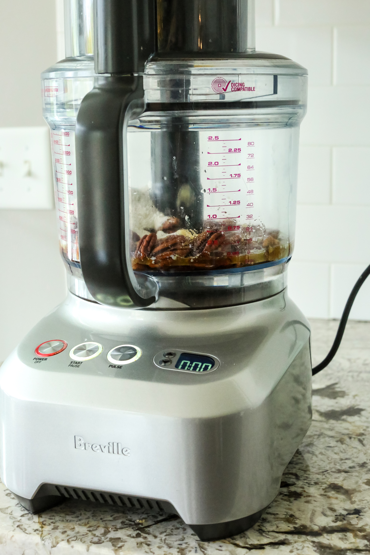 pecans, flour, and other ingredients in a food processor