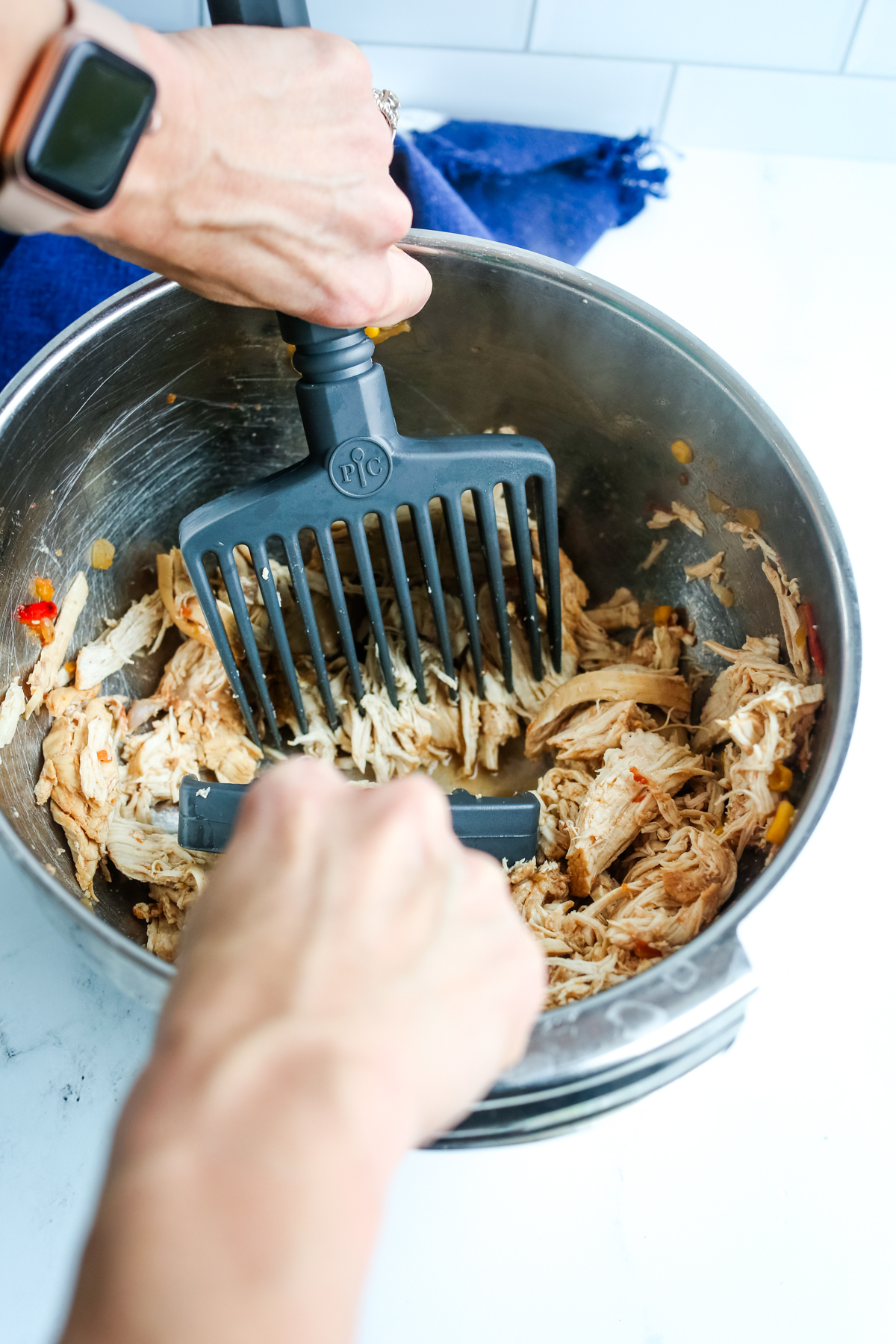 shredding chicken in a bowl