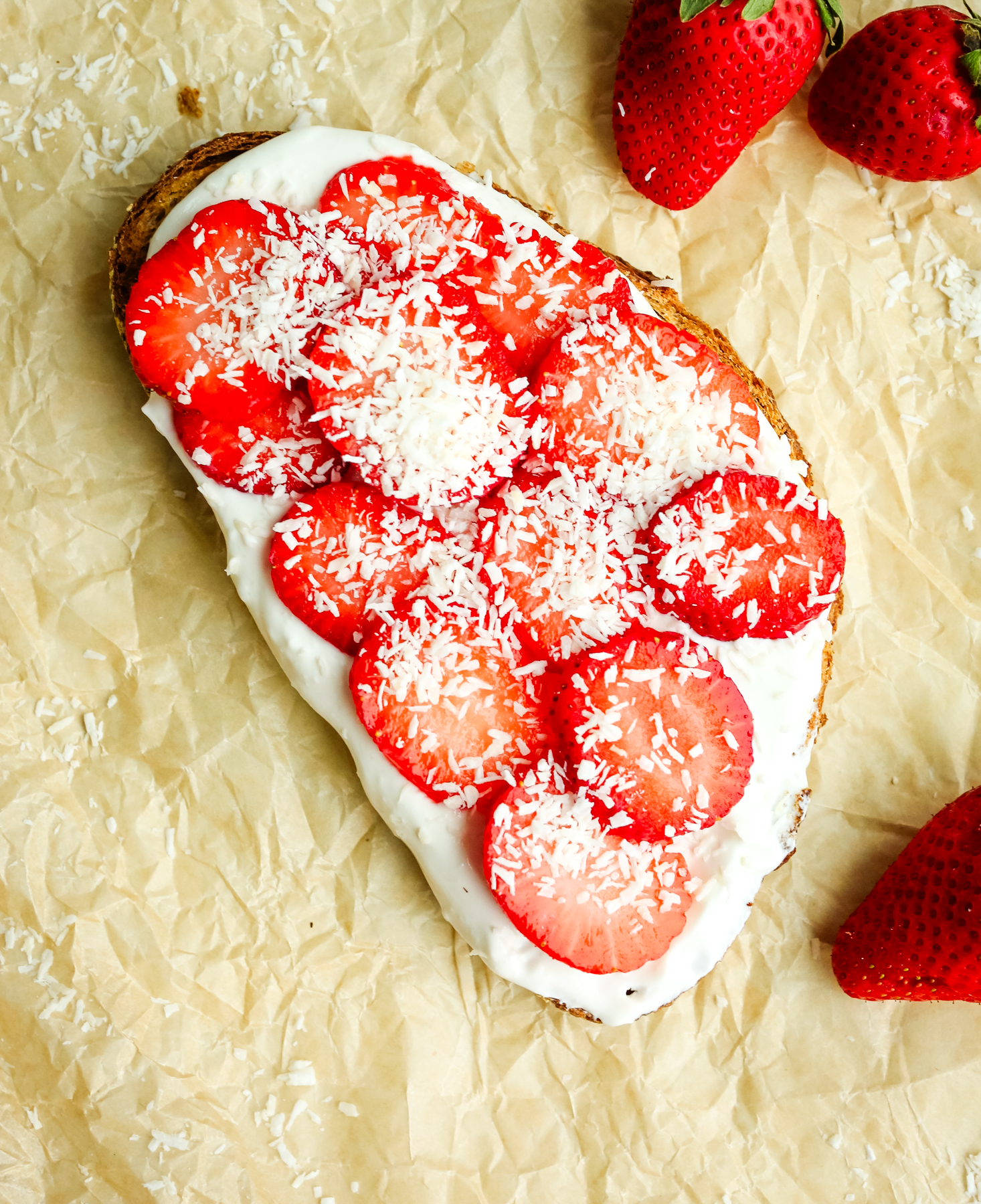 Toast with fresh strawberries and shredded coconut toppings