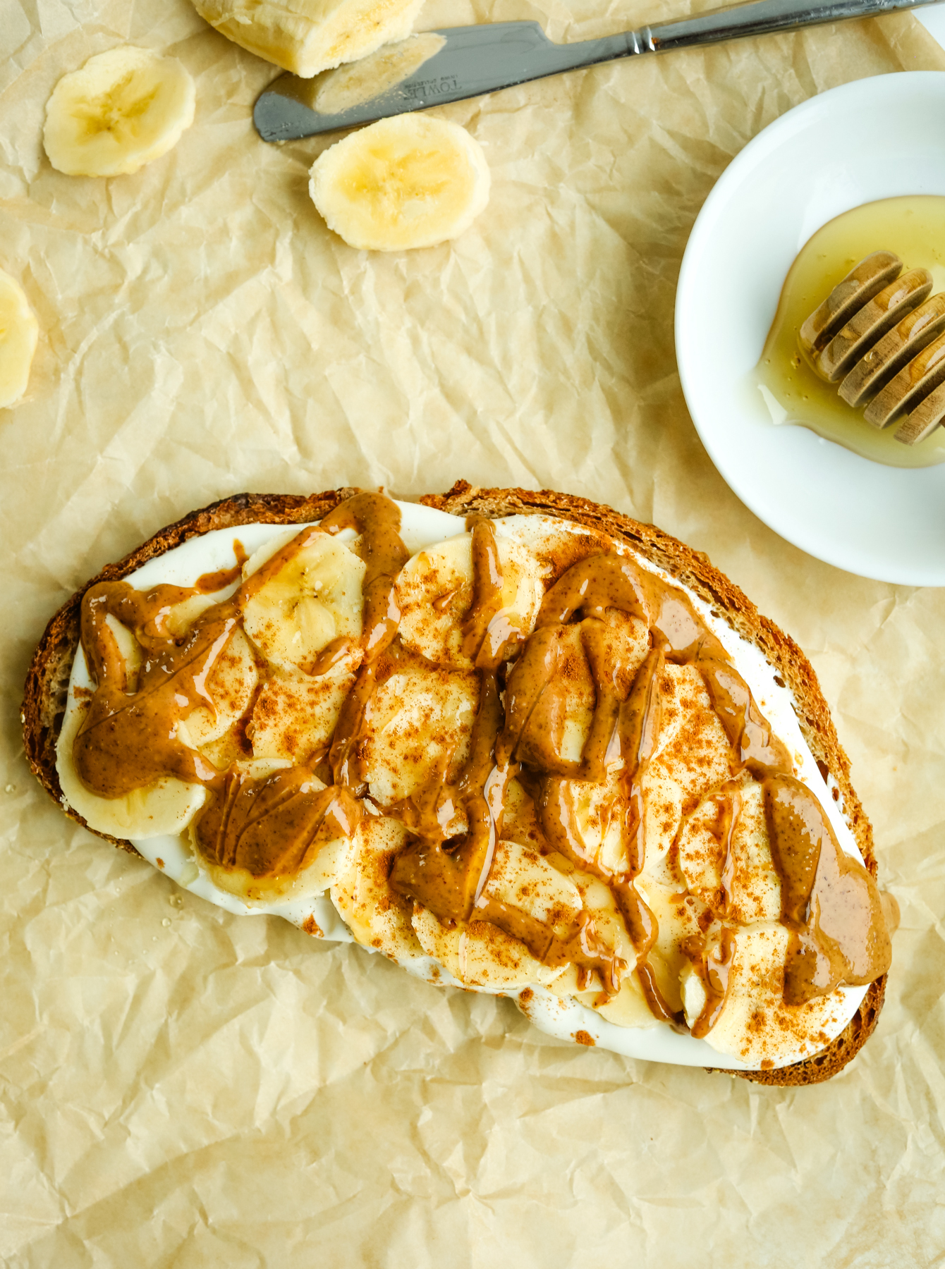 toast with sliced bananas almond butter, and honey topping