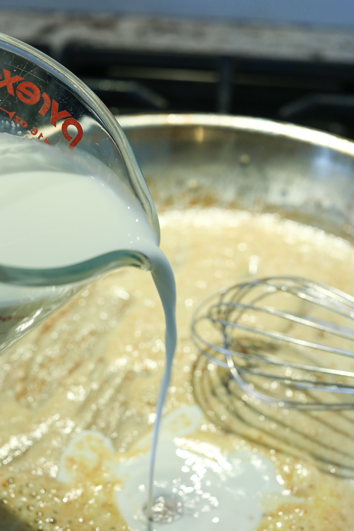 pouring milk into a skillet
